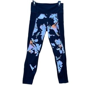 Athleta leggings floral mesh at the bottoms, side slip pockets, multi color